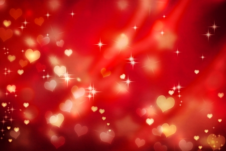 Golden small hearts on red background with starsの写真素材