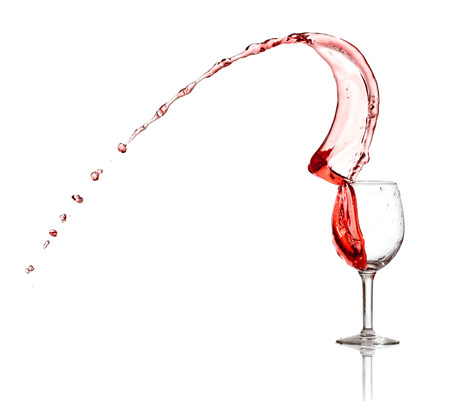 Red wine splash from a glass isolated on white backgroundの写真素材