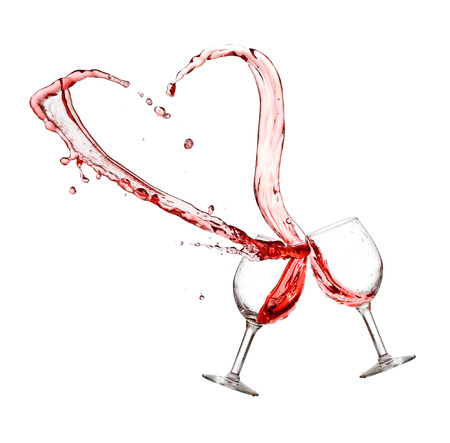 Heart splash from two glasses of red wine isolated on white backgroundの写真素材