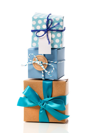 Stack of handcraft blue colored gift boxes on white background の写真素材