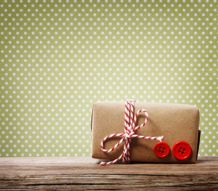 Handmade gift box over green polka dotsの写真素材