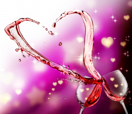 Heart splash from two glasses of red wine over abstract hearts light backgroundの写真素材