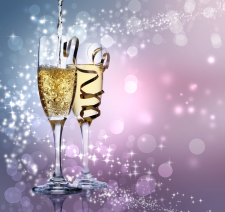 Two champagne glasses over shiny purpleの写真素材