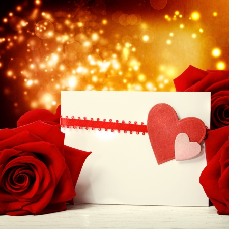 Hearts greeting card with beautiful red roses over abstract lights の写真素材