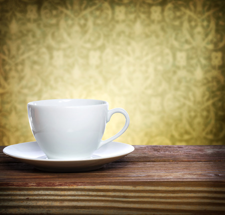 Coffee cup over fancy wallpaper backgroundの写真素材