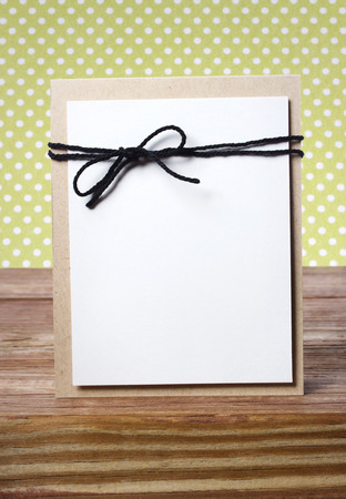 Handmade card on wooden table over polka dots backgroundの写真素材