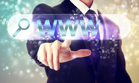 Businessman pressing WWW search button on shiny backgroundの写真素材