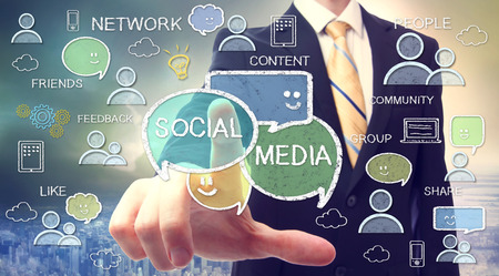 Businessman pointing at social media texts and cartoonの写真素材