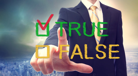 Businessman pointing at TRUE or FALSE checkboxの写真素材