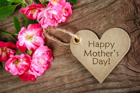 Heart shaped mothers day card with roses on wood backgroundの写真素材