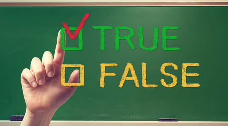 TRUE or FALSE checkbox with hand on green chalkboardの写真素材