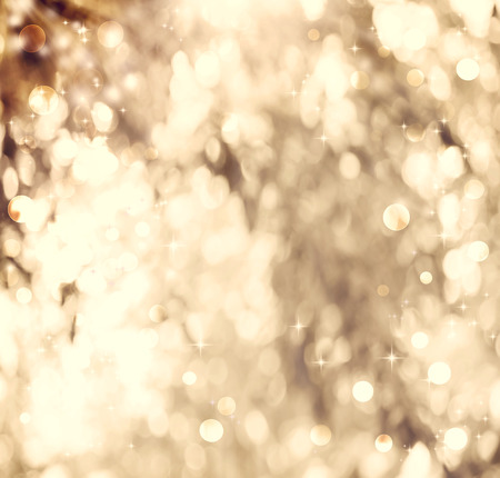 Golden colored abstract shiny light and glitter backgroundの写真素材