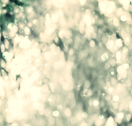 Gold and green colored abstract shiny light and glitter backgroundの写真素材