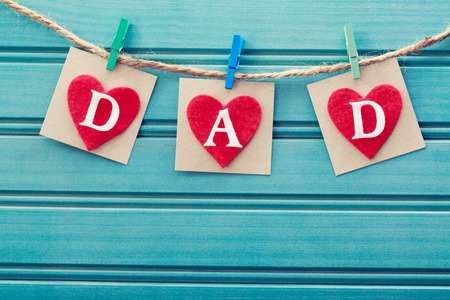 Fathers day message on felt hearts over blue wooden boardの写真素材