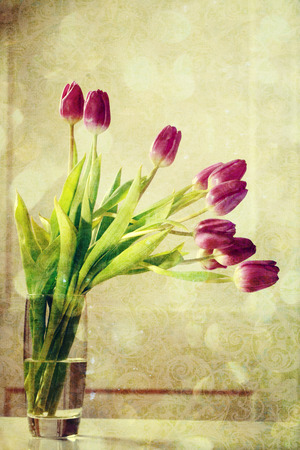 Beautiful purple tulips in a vase in a vintage styleの写真素材