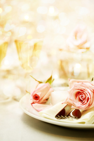 Decorated dinner table with beautiful pink rosesの写真素材