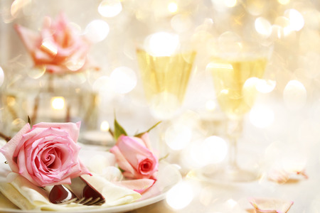 Decorated dinner table with beautiful pink rosesの写真素材