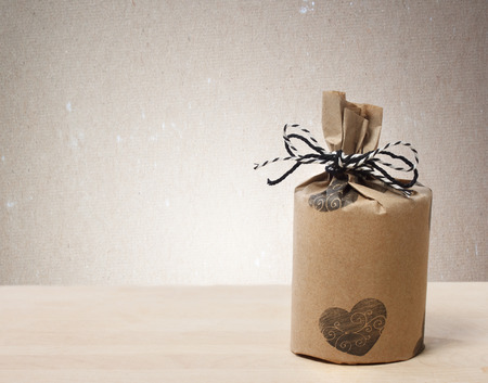 Presents wrapped in a rustic earthy style on beige paper backgroundの写真素材