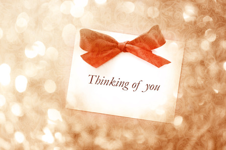Thinking of you message with red ribbon on vintage light backgroundの写真素材