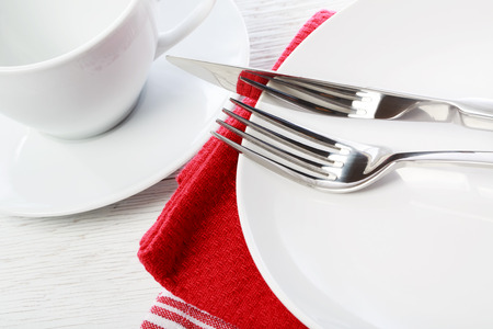 Empty coffee cup and plate on red napkinsの写真素材