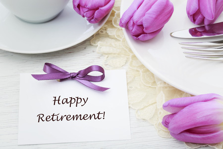 Happy Retirement message with table setting and purple tulipsの写真素材