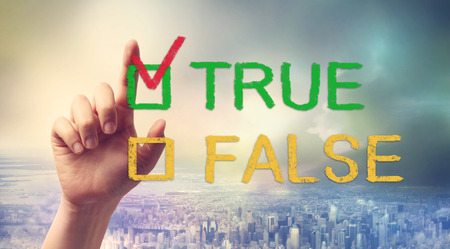 Hand pointing at TRUE or FALSE checkboxの写真素材