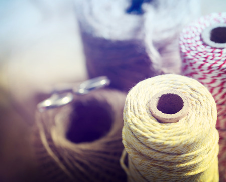 Spools of different color string with scissorsの写真素材