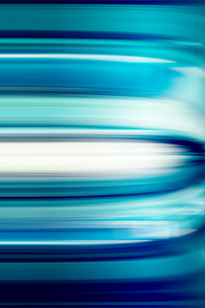 Abstract blue, aqua and white motion blurred backgroundの写真素材