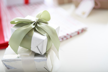 Handmade present boxes with light green ribbon