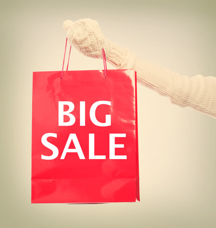 Woman holding Big Sale red shopping bagの写真素材