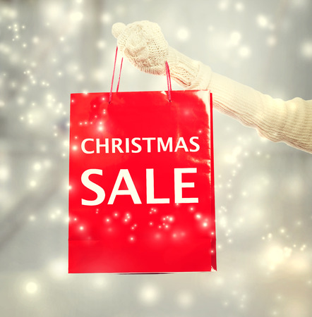 Woman holding red Christmas Sale shopping bagの写真素材