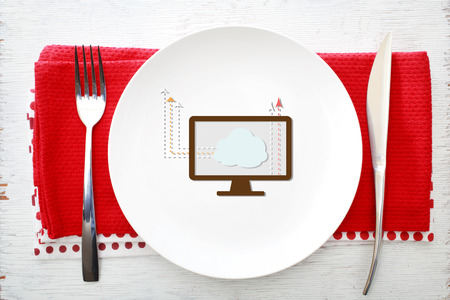 Cloud Computing concept on white plate with fork and knife on red napkinsの写真素材