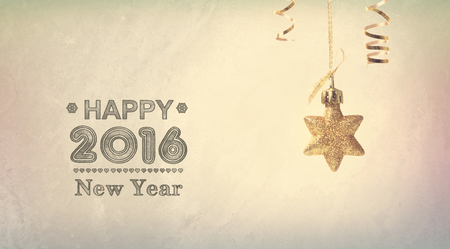 Happy New Year 2016 message with a hanging star ornamentの写真素材