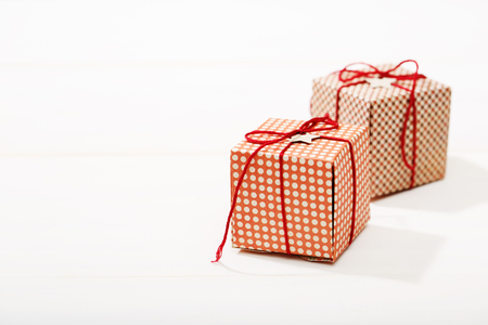 Handmade small red gift boxes on white wooden tableの写真素材