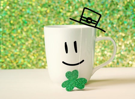 Saint Patricks Day green clover with happy face on white mugの写真素材
