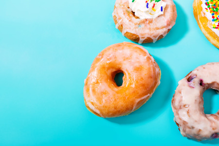 Assorted donuts on a pastel blue backgroundの写真素材
