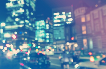 Blurred blue and pink urban building background illuminated at nightの写真素材