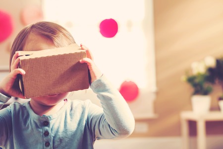 Toddler girl using a new virtual reality headsetの写真素材