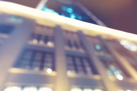 Blurred blue and pink urban building background illuminated at night