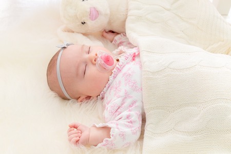 Newborn baby girl laying on her blanketの写真素材