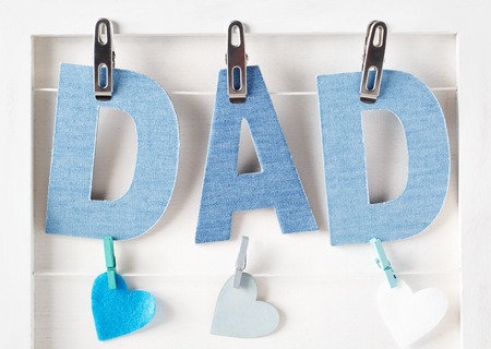 Blue Dad texts and hearts hanging with clothespinsの写真素材