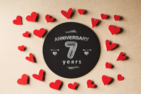 Anniversary 7 years message with handmade small paper heartsの写真素材