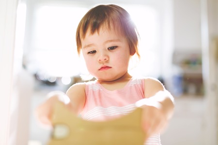 Toddler girl using a new virtual reality headsetの写真素材