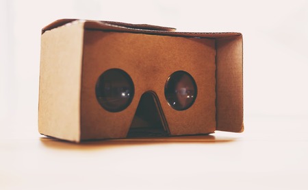 Virtual reality cardboard headset on a table in natural lightの写真素材