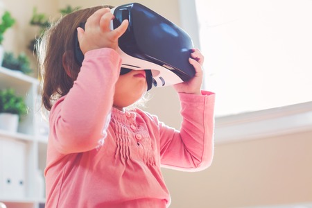 Toddler girl using a new virtual reality headsetの写真素材