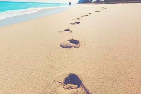 Footprints left in the sand of a tropical beachの写真素材