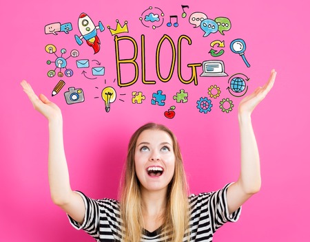 Blog concept with young woman reaching and looking upwardsの写真素材