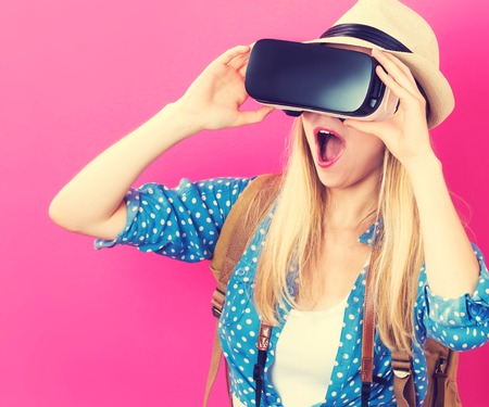 Happy young woman using a virtual reality headsetの写真素材