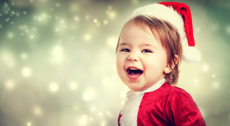 Happy Toddler girl with a Santa hatの写真素材