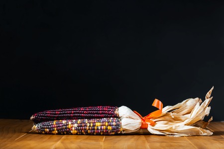 Ear of Indian corn in on vintage wood table topの写真素材
